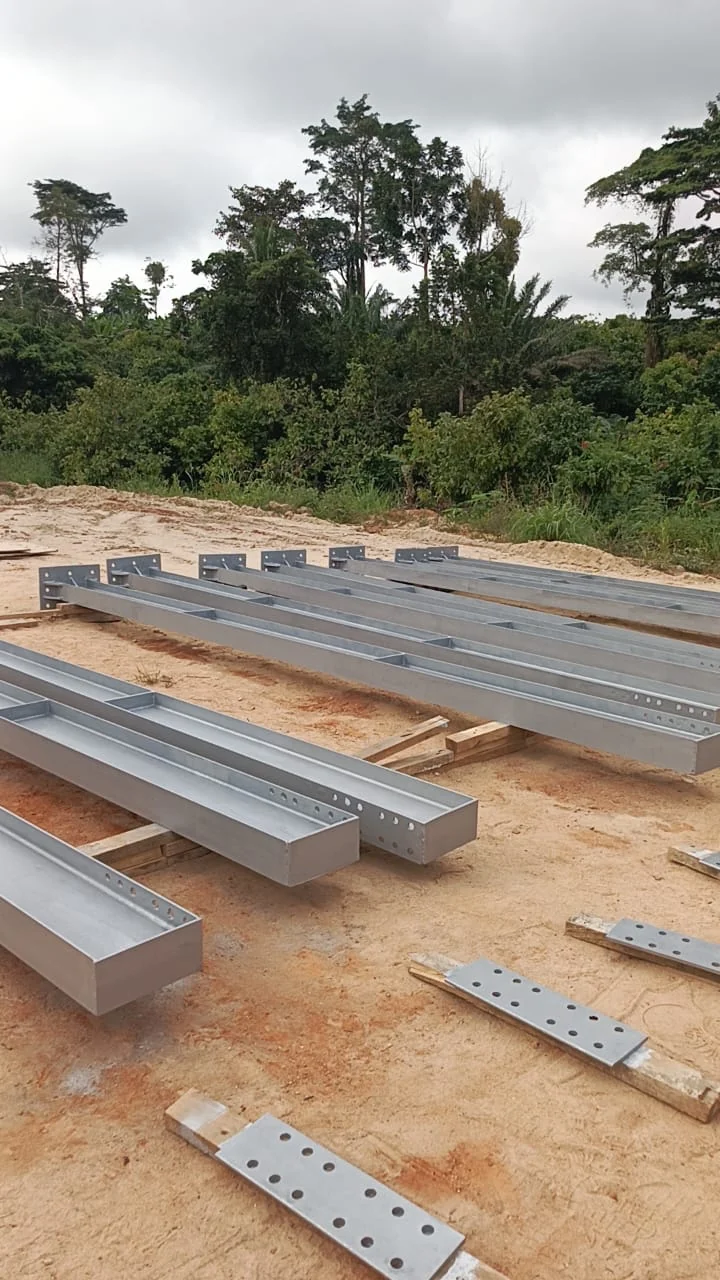 Prepared structural steel beams on a Ghanaian construction site